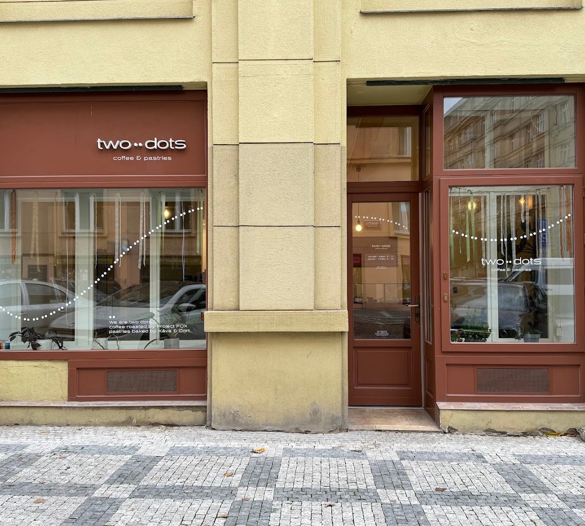 Storefront of two dots coffee & pastries, specialty coffee shop in Prague