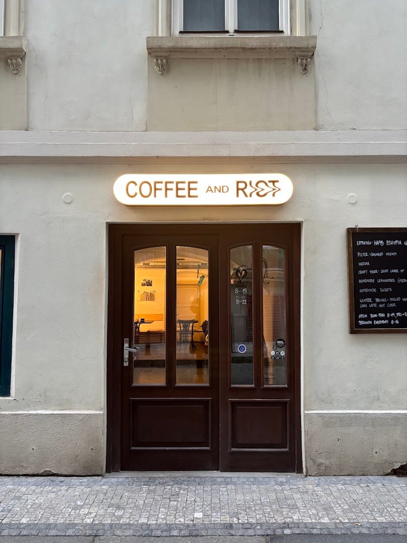 Storefront of Coffee and Riot, specialty coffee shop in Prague