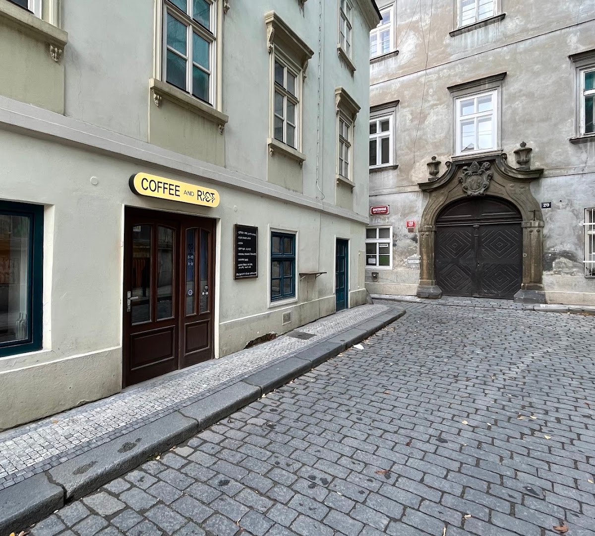 Storefront of Coffee and Riot, specialty coffee shop in Prague
