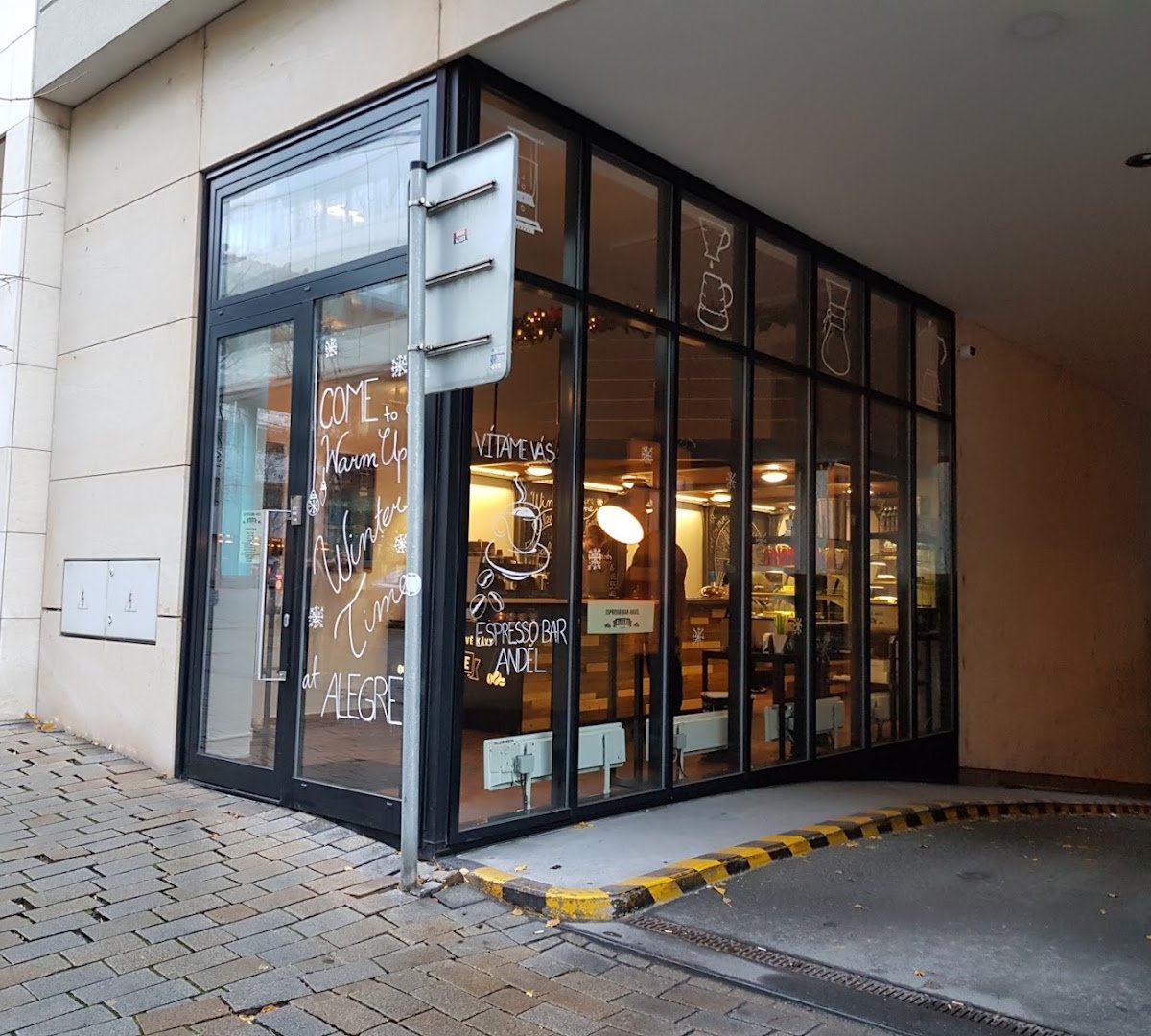 Storefront of Café Alegre, specialty coffee shop in Prague