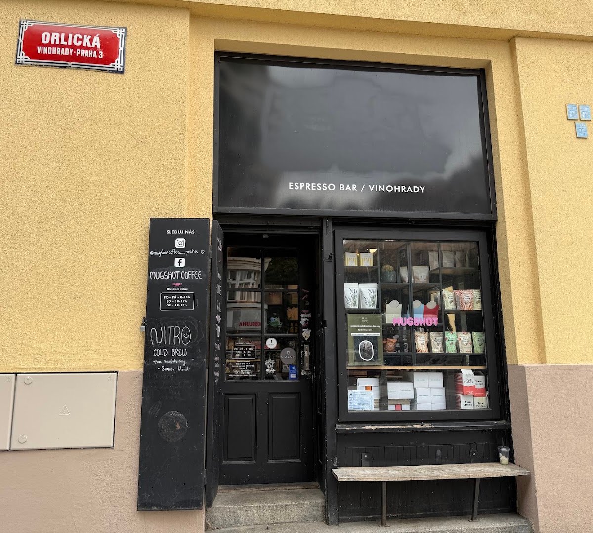 Storefront of Mugshot Coffee, specialty coffee shop in Prague