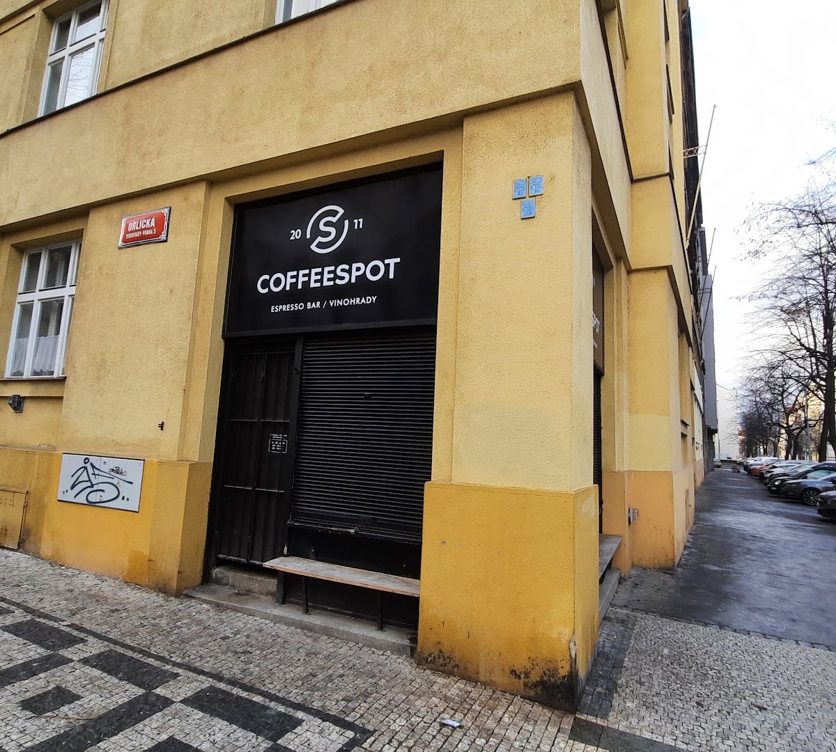 Storefront of Mugshot Coffee, specialty coffee shop in Prague