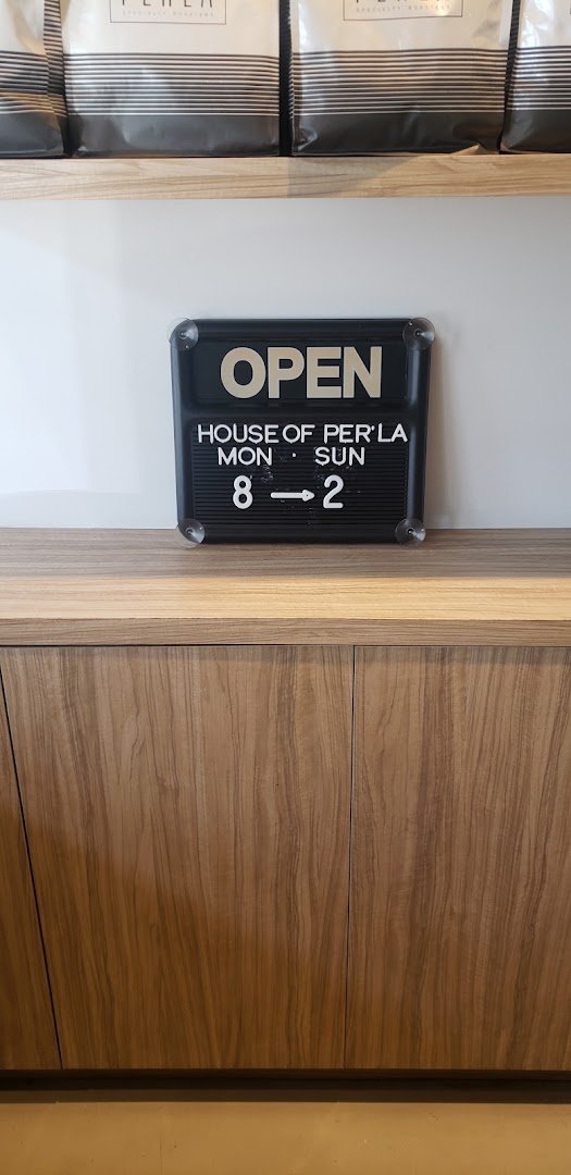 Signage at Per'La Coffee, specialty coffee shop in Miami