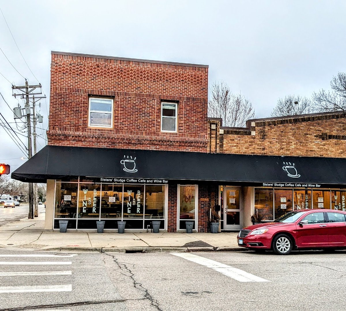 Storefront of Sisters' Sludge Coffee Cafe and Wine Bar, specialty coffee shop in Minneapolis