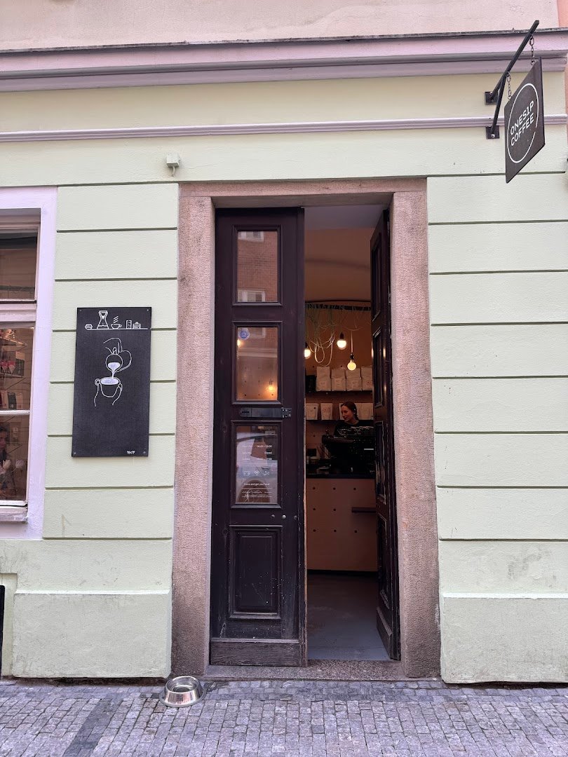 Storefront of onesip coffee, specialty coffee shop in Prague