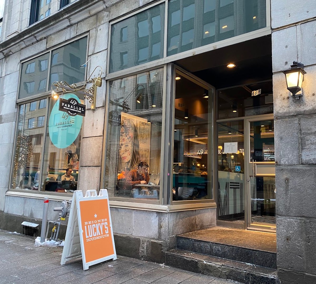 Storefront of 49th Parallel Café & Lucky’s Doughnuts - McGill, specialty coffee shop in Montreal